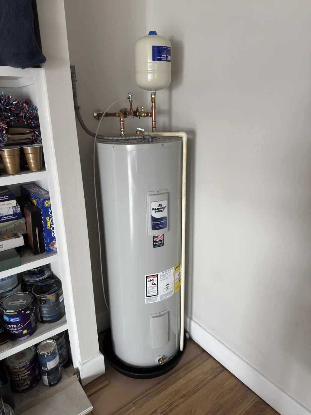 Water heater installation with copper connections and expansion tank, photographed by Discount Drain and Rooter